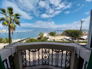 a balcony with a view of the ocean at Alexander history spot in Alexandria