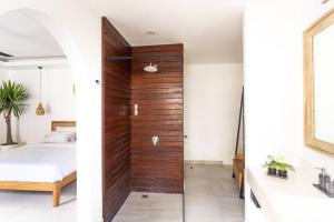 a bedroom with a wooden door leading to a bed at Beautiful 1-Bedroom-Villa 'Sunflower' in Canggu in Dalung