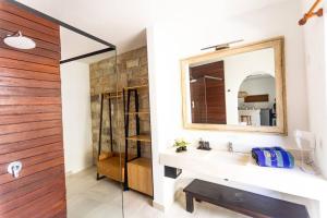 a bathroom with a sink and a mirror at Beautiful 1-Bedroom-Villa 'Sunflower' in Canggu in Dalung