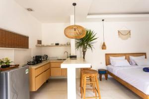 a kitchen and a bedroom with a bed and a table at Beautiful 1-Bedroom-Villa 'Sunflower' in Canggu in Dalung