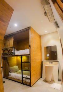 a small room with a bunk bed in it at DBeds Kuta Beach By Destiny Hospitality in Kuta