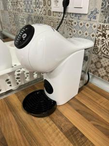 a white hair dryer sitting on the floor in a bathroom at PRADALONGO in Madrid