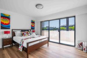 a bedroom with a bed and a large window at Mountain Waves in Barrack Point