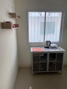 a room with a window and a table with a tea kettle on it at Superb studio Apartment in Ban Na Khua