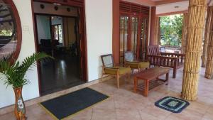 a living room with chairs and a table and a mirror at Rohana Holiday Resort yala in Tissamaharama