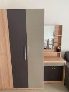 an open cabinet in a room with a desk at Superb studio Apartment in Ban Na Khua