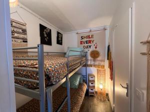 a small room with a bunk bed and a staircase at Azur, a 100m du marché de Noel, appartement 4 personnes et parking privé in Le Barcarès