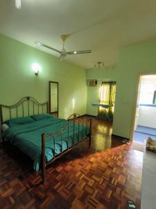 a bedroom with a bed and a ceiling fan at Acuk Stay - Seri Maya Condo Homestay in Kuala Lumpur