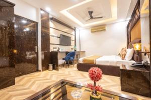 a hotel room with a bed and a glass table at Hotel Cosmo Karol Bagh in New Delhi