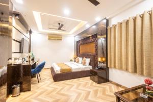 a hotel room with a bed and a desk at Hotel Cosmo Karol Bagh in New Delhi