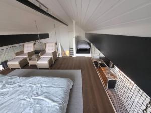 a room with a bed and chairs in it at beautiful villa with seaview and sunny in Askøy