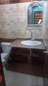 a bathroom with a sink and a toilet and a mirror at HaYaH Guest house in Aswan