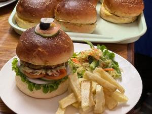 a plate of food with a hamburger and french fries at Hotel Eco View Point Pvt.Ltd in Tāplejung