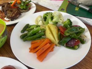 two plates of food with vegetables on a table at Hotel Eco View Point Pvt.Ltd in Tāplejung