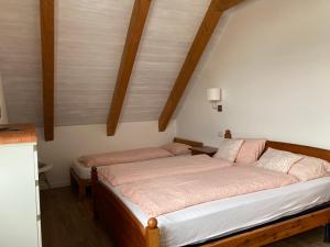 um quarto com uma cama grande e lençóis cor-de-rosa em La Pioda Vigezzo Santa Maria Maggiore Locazione Turistica em Santa Maria Maggiore