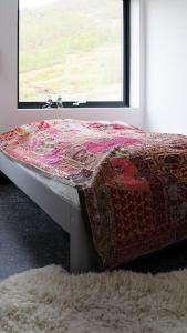 uma cama num quarto com uma janela em Cozy Retreat and danish design in Nature's Splendor, Sogn, Norway, Jacuzzi-option available em Sogndal