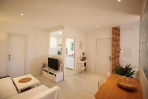 a living room with a table and a dining room at Ground floor with garden, swimming pool and private parking in Sóller