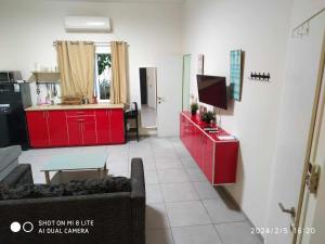 a living room with red cabinets and a kitchen at Amir's Apartments in Tel Aviv