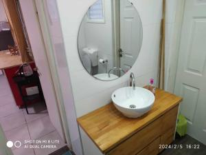 a bathroom with a sink and a mirror at Amir's Apartments in Tel Aviv