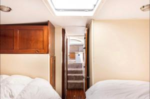 a bedroom with a bed and a cabinet and a staircase at Barco Americano Sotogrande in Torreguadiaro