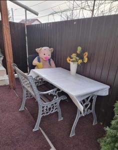 a teddy bear sitting at a table with a teddy bear at Roman Residence in Roman
