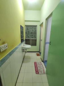 a bathroom with a sink and a mirror at Acuk Stay - Seri Maya Condo Homestay in Kuala Lumpur