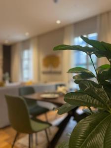 a plant in a living room with a table and chairs at luxury apartment AL Majdiah Residence N,Hittin,Boulevard, البوليفارد in Riyadh