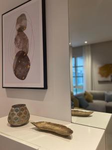 two vases sitting on a counter in a living room at luxury apartment AL Majdiah Residence N,Hittin,Boulevard, البوليفارد in Riyadh