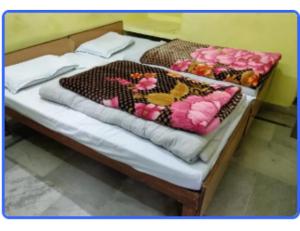 a bed with a bunch of flowers on it at Hotel Chandradeep, Joshimath in Joshīmath