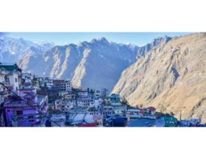 a view of a city with mountains in the background at Hotel Chandradeep, Joshimath in Joshīmath