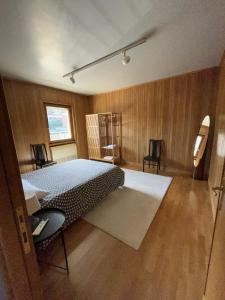 a bedroom with a bed in a room with wooden walls at The Attic Apartment in Rome