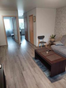 a living room with a couch and a coffee table at Apartamentai ,,ASTRA'' in Birštonas