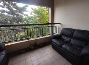 a living room with a couch and a large window at Acuk Stay - Seri Maya Condo Homestay in Kuala Lumpur