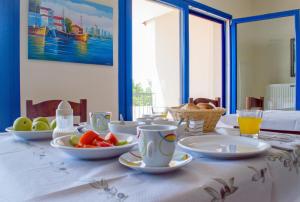 un tavolo con una tovaglia da tavola con sopra del cibo di Hotel Alexandros a Fanárion