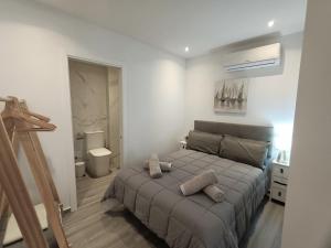a bedroom with a bed with two pillows on it at Marbella-Peñuelas Old Town Apartments in Marbella +58 photos