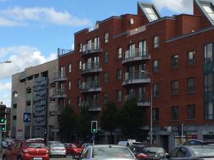 a large red brick building with cars parked in front of it at 39 Camden Wharf in Cork