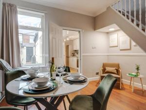 a dining room with a table and chairs at Pass the Keys Tranquil Green Retreat - 3 Bed Tuebrook Terrace in Liverpool