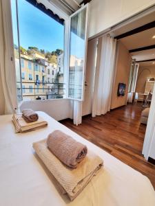 a bedroom with a bed and a large window at In Old Nice, with A/C, quiet, for foodies and art lovers in Nice