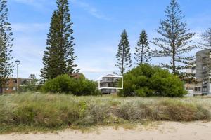 a house on the beach with trees and bushes at Penthouse in Gold Coast in Gold Coast