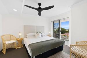 a bedroom with a bed and a ceiling fan at Penthouse in Gold Coast in Gold Coast