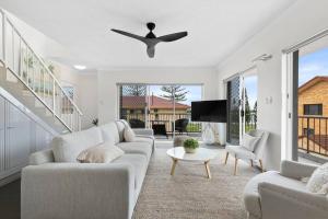 a living room with a couch and a ceiling fan at Penthouse in Gold Coast in Gold Coast