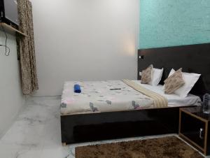 a small bedroom with a bed with white sheets and pillows at The blessings home stay in Agra