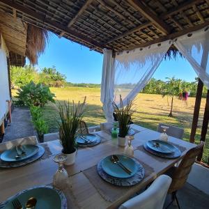a wooden table with blue plates on it with a view of a field at Casa Juan Farm in Candelaria
