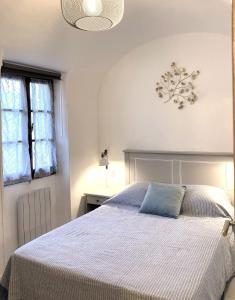 a bedroom with a bed with a blue pillow on it at DOLCE VITA CIAIXE in Camporosso