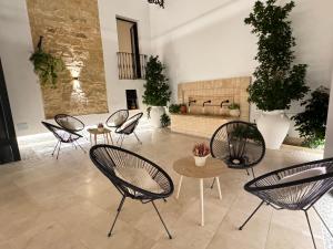 a group of chairs and tables in a room at Casa Boutique Navarro in Montilla