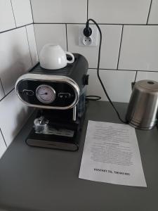 a coffee maker with a cup on top of it at Apartament mieszkanie dostęp zdalny bez potrzeby odbioru kluczy in Giżycko