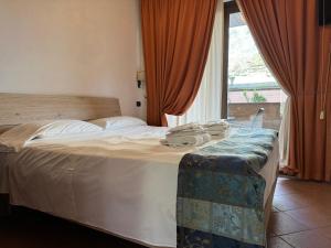 a bed in a hotel room with a large window at EURO HOUSE INN airport in Fiumicino
