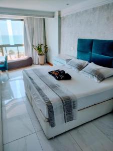 um quarto com uma cama grande e uma cabeceira azul em RICARDO Pousada - SUITE MASTER em Vila Velha