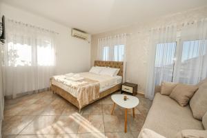 a bedroom with a bed and a couch at Villa Lux Rajović in Budva +48 photos