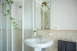 a bathroom with a sink and a mirror at Beach House Roccalumera in Roccalumera